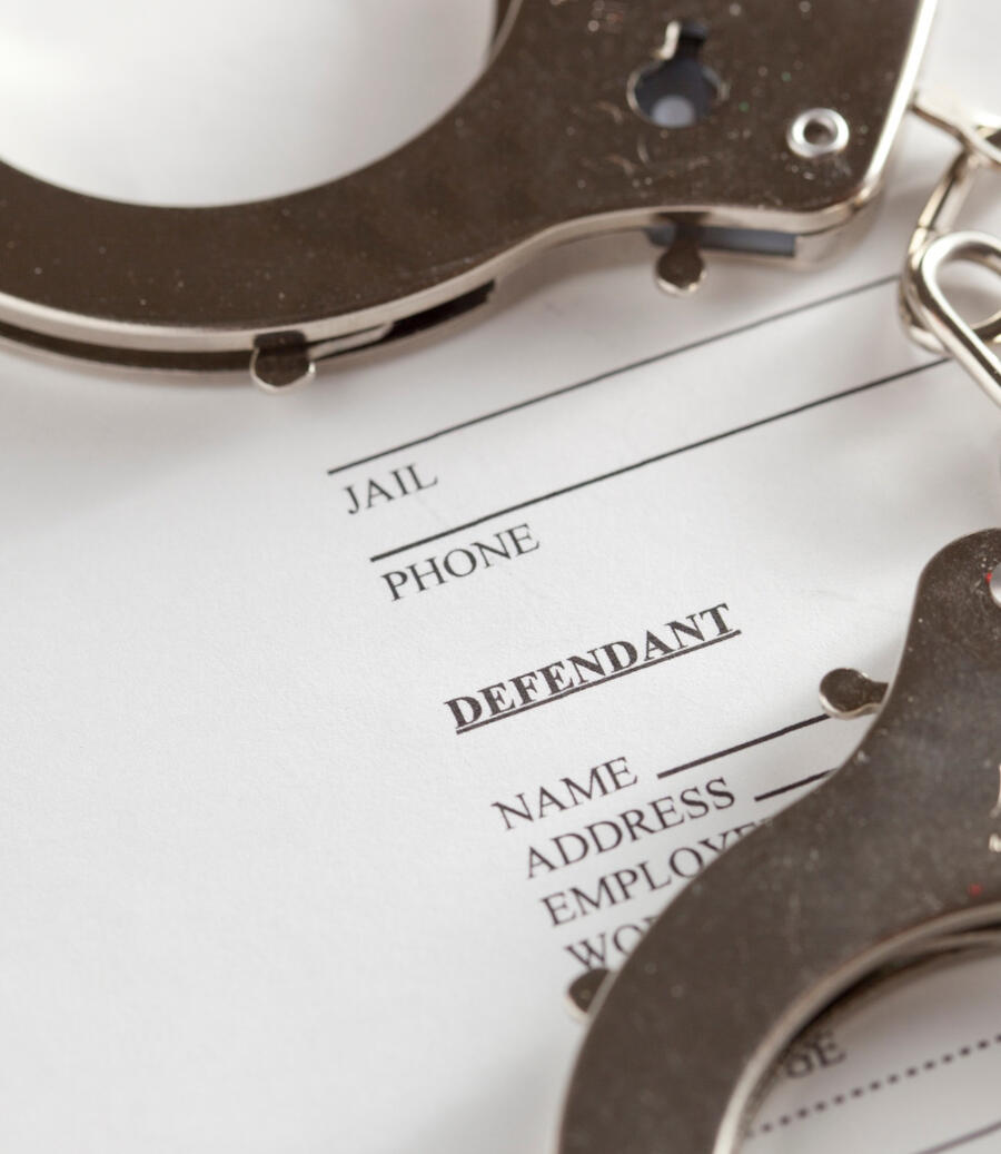 Handcuffs placed on top of a bail bond application